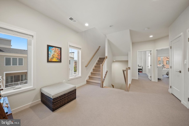 interior space with visible vents, carpet, and baseboards