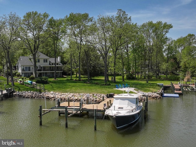 view of dock featuring a water view and a yard