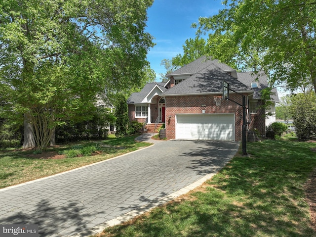view of front facade with a garage, a front yard, driveway, and brick siding