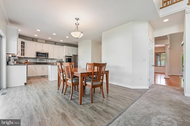 dining area with baseboards, decorative columns, recessed lighting, and light wood-style flooring