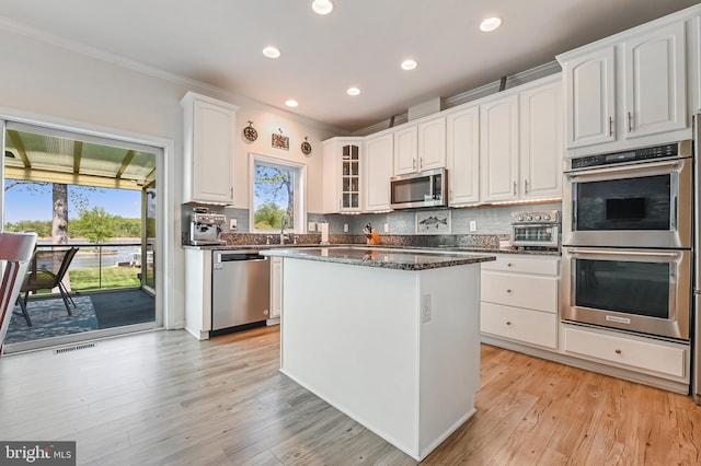 kitchen with visible vents, recessed lighting, white cabinetry, backsplash, and stainless steel appliances