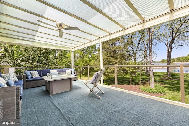 view of patio featuring a water view, ceiling fan, and outdoor lounge area