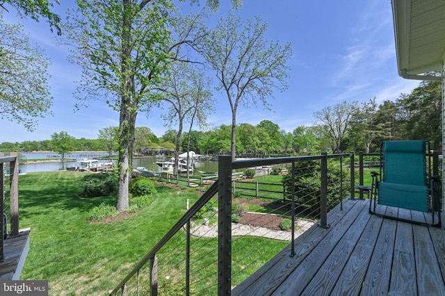 wooden deck featuring a yard and a water view