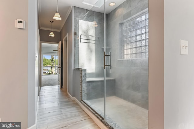 bathroom featuring crown molding, baseboards, and a stall shower