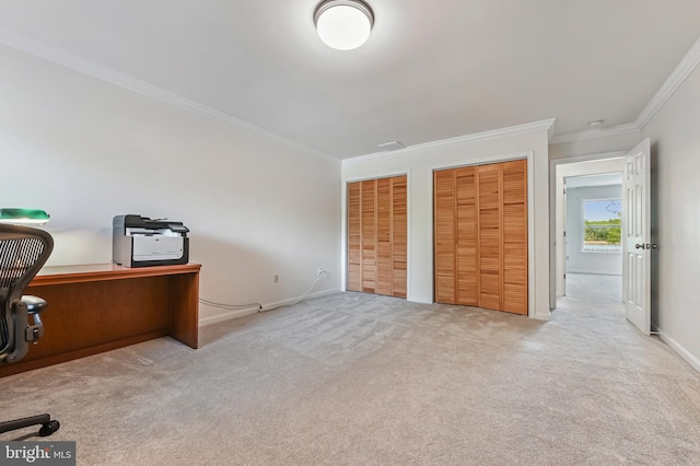 carpeted office space with crown molding and baseboards
