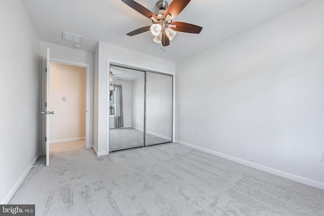 unfurnished bedroom with carpet flooring, baseboards, visible vents, and a closet