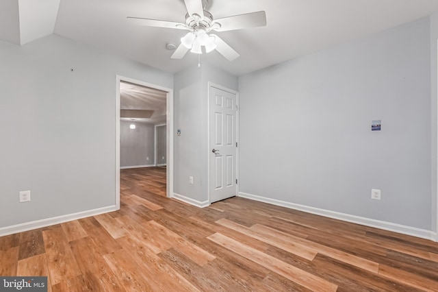 empty room with light wood-type flooring, baseboards, and ceiling fan