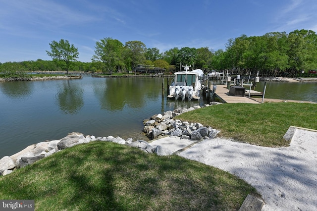 dock area with a lawn, a water view, and boat lift
