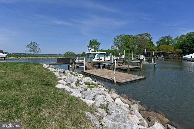 view of dock with boat lift and a water view