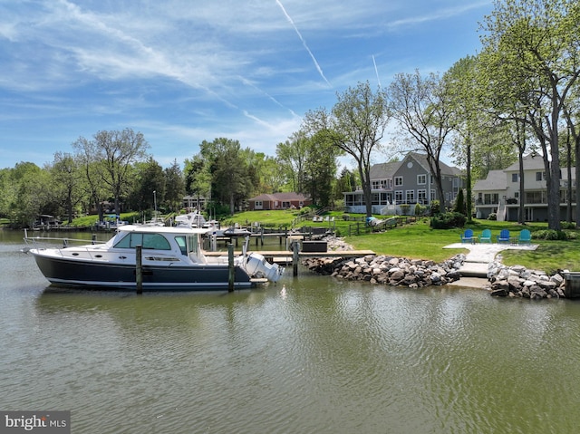 dock area featuring a water view and a yard