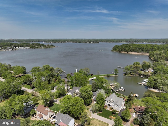 drone / aerial view with a water view and a residential view