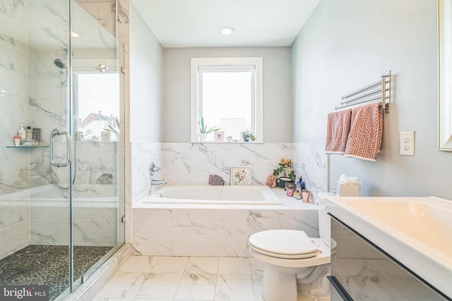 bathroom with a garden tub, vanity, toilet, marble finish floor, and a marble finish shower