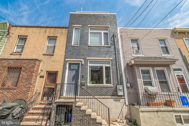 townhome / multi-family property featuring brick siding and cooling unit