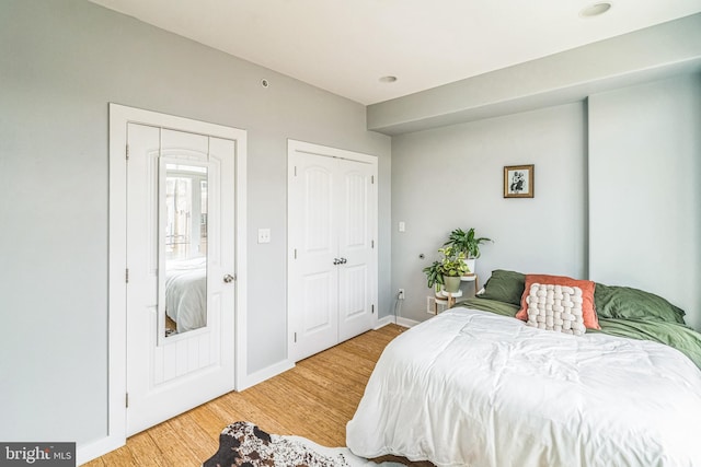 bedroom with baseboards and light wood finished floors