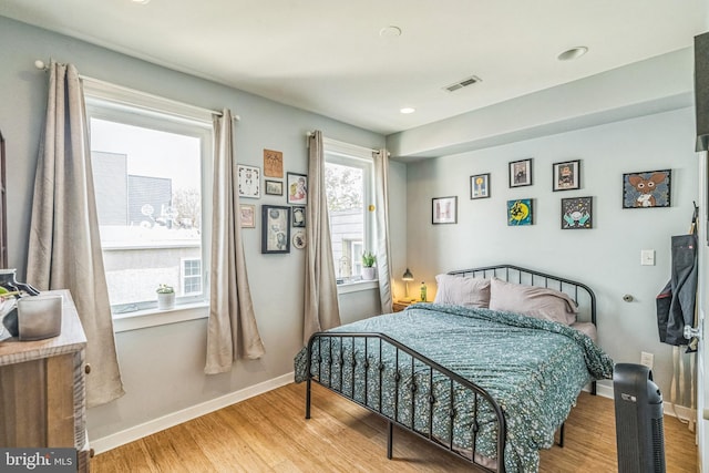 bedroom featuring visible vents, recessed lighting, baseboards, and wood finished floors