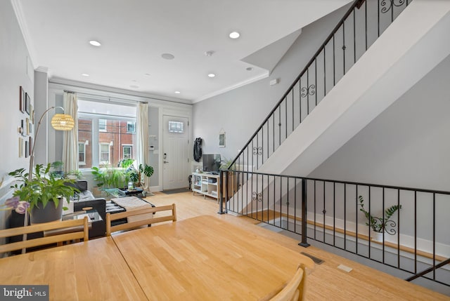 dining room featuring baseboards, ornamental molding, recessed lighting, and stairs