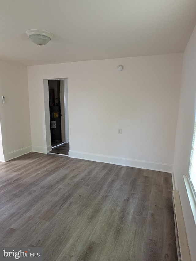 405 Poplar St, Salisbury, MD 21804 - spare room with baseboards, a baseboard radiator, and dark wood-style floors