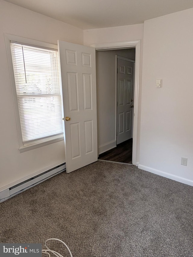 405 Poplar St, Salisbury, MD 21804 - unfurnished room featuring baseboards, a baseboard radiator, and dark carpet