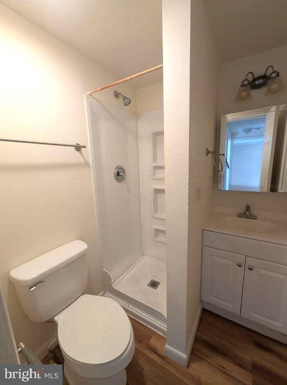405 Poplar St, Salisbury, MD 21804 - full bath with toilet, wood finished floors, vanity, a stall shower, and baseboards