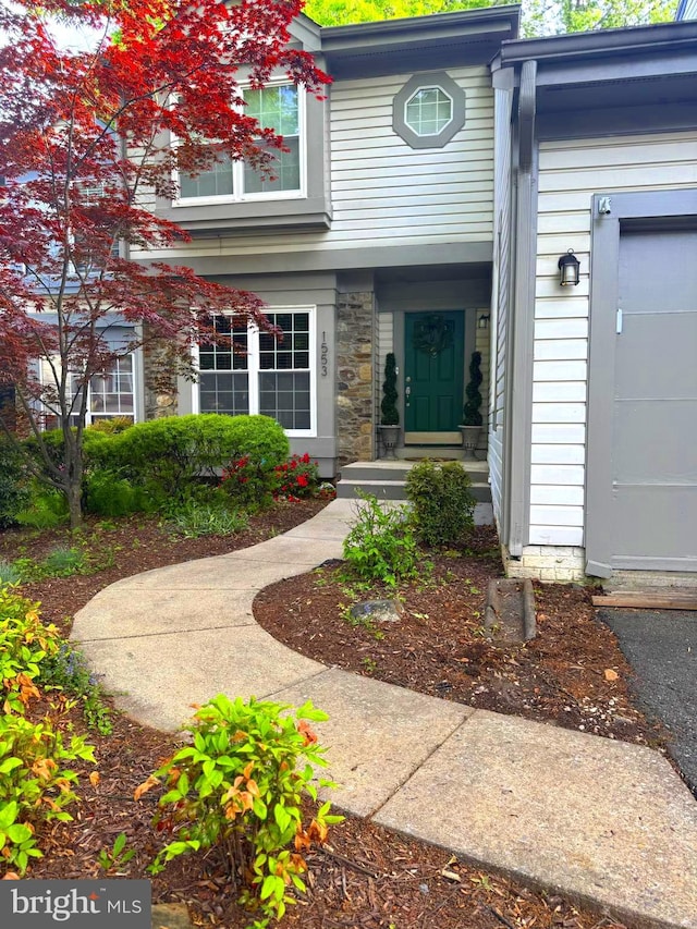 property entrance featuring stone siding