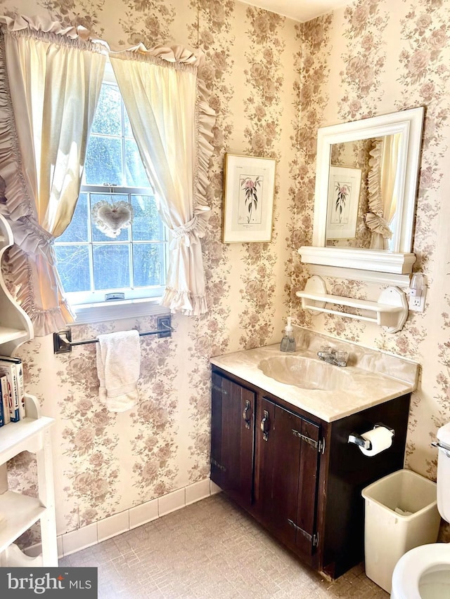6908 Baltimore Ave, Hyattsville, MD 20782 - bathroom featuring wallpapered walls, vanity, toilet, and baseboards