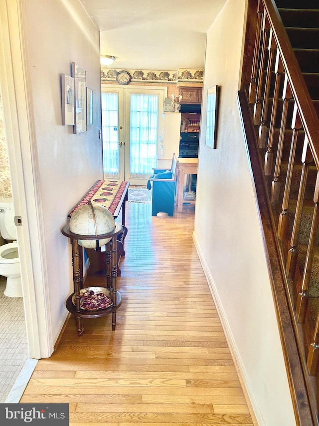 6908 Baltimore Ave, Hyattsville, MD 20782 - hall with hardwood / wood-style flooring, stairway, baseboards, and french doors