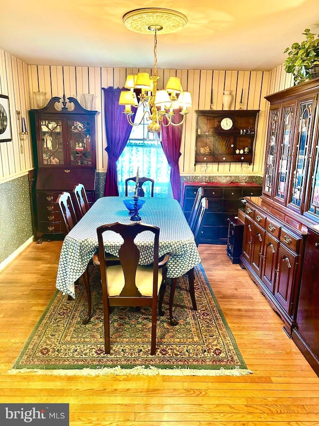 6908 Baltimore Ave, Hyattsville, MD 20782 - dining area featuring a chandelier, light wood-type flooring, and wallpapered walls