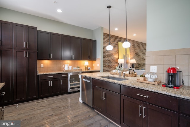 kitchen with dark brown cabinetry, dishwasher, a sink, wine cooler, and light wood-style flooring