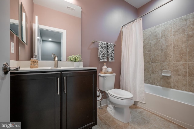 full bathroom featuring shower / bath combination with curtain, visible vents, tile patterned floors, vanity, and toilet