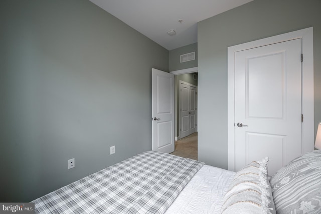 bedroom with visible vents and carpet floors