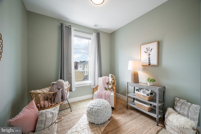 sitting room featuring baseboards, carpet, and visible vents