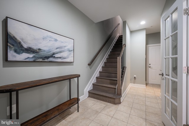 stairway with tile patterned flooring, recessed lighting, and baseboards
