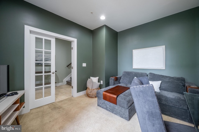 living room with baseboards, carpet, french doors, and stairs
