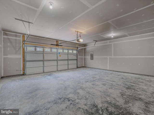 garage with a garage door opener and electric panel