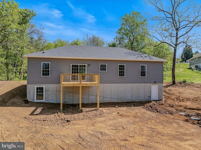back of property with a wooden deck