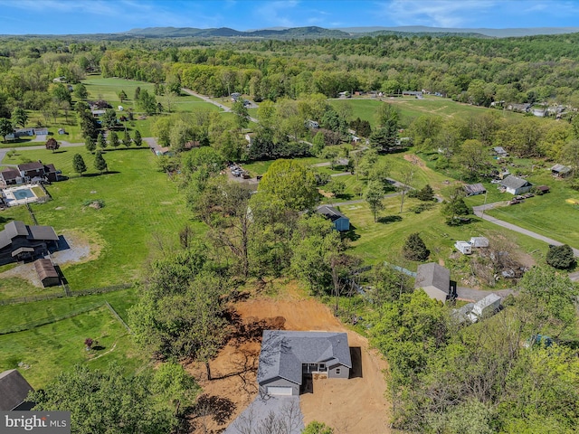 drone / aerial view featuring a wooded view