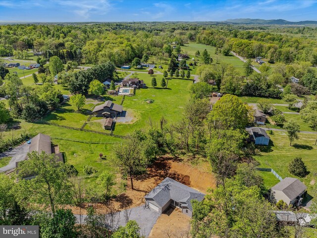 drone / aerial view featuring a wooded view