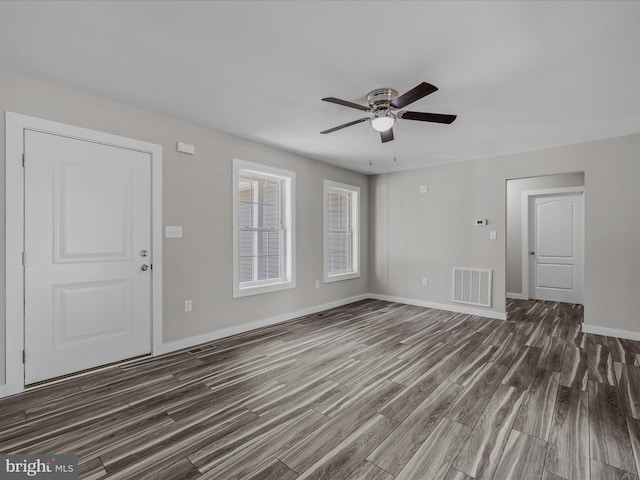 unfurnished living room with visible vents, baseboards, ceiling fan, and wood finished floors