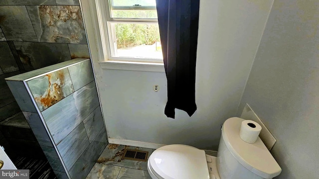 bathroom with visible vents and toilet