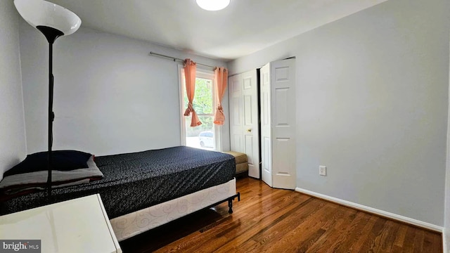 bedroom featuring baseboards and wood finished floors