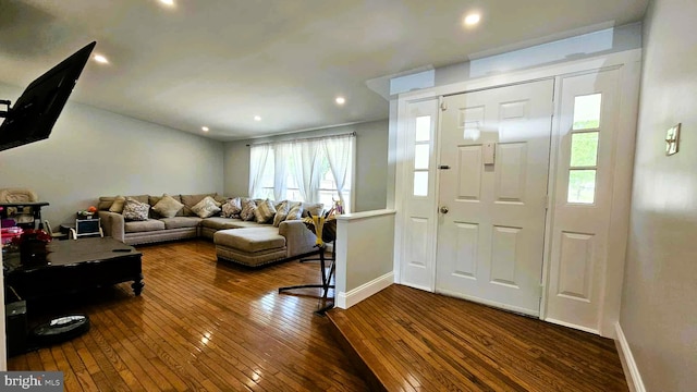 interior space featuring recessed lighting, baseboards, and dark wood finished floors