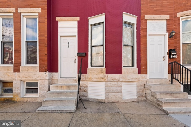 entrance to property featuring stone siding