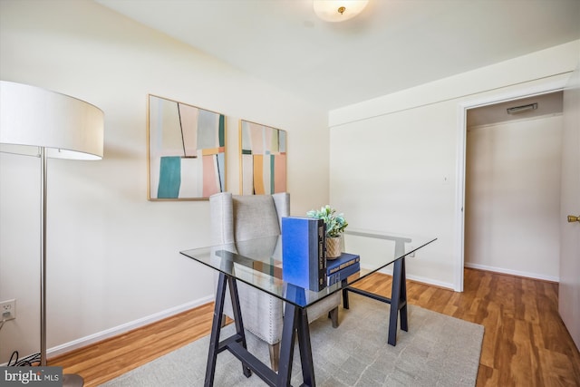 home office with wood finished floors and baseboards