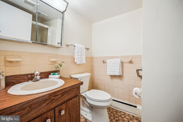 full bath featuring a baseboard radiator, a shower stall, toilet, vanity, and wainscoting
