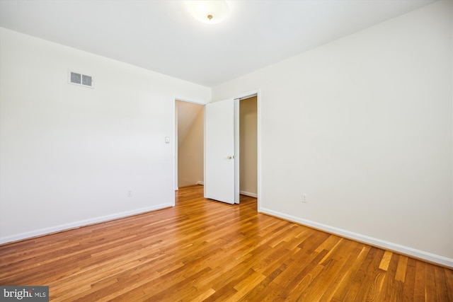 unfurnished room featuring light wood finished floors and baseboards
