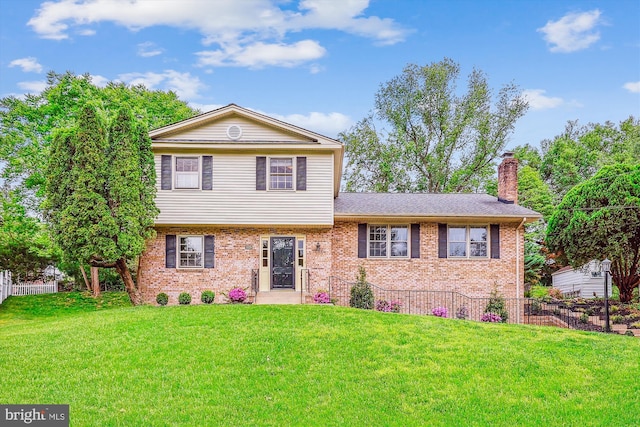 view of front of property with a chimney and brick siding