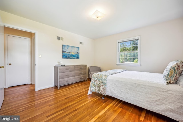 bedroom with wood finished floors and baseboards