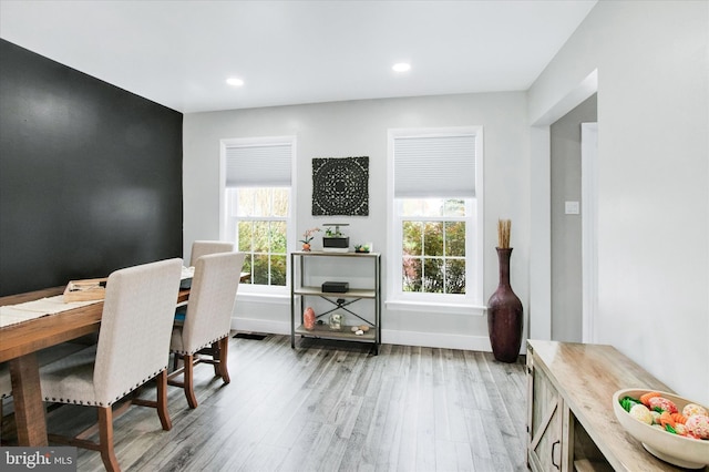 dining space with light wood-style floors, plenty of natural light, and recessed lighting