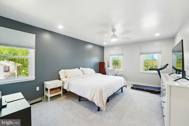 bedroom with baseboards, recessed lighting, and light colored carpet