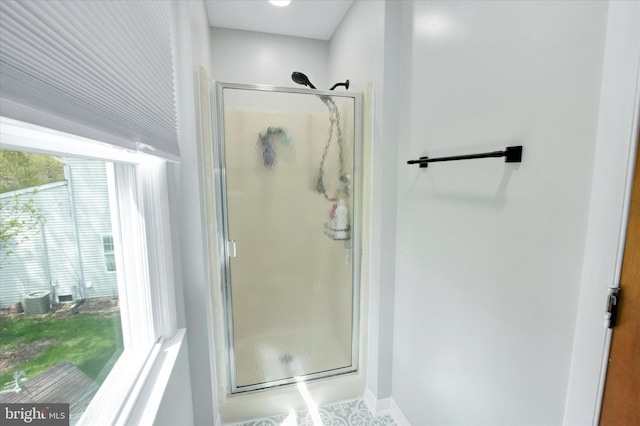 bathroom featuring baseboards and a shower stall